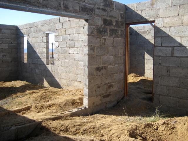 From the kitchen, looking into the sitting room on the left and the door to the garage on the right.