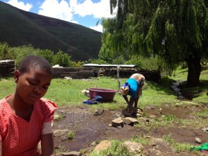 Helping wash laundry at the river